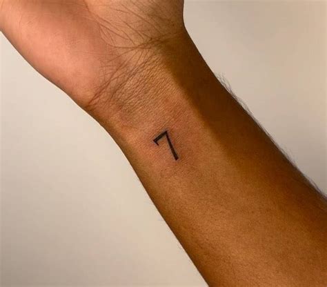 Tattoo of the number "7" located on the wrist.