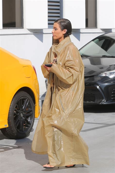 Kanye West's wife Bianca Censori hides her stomach as she poses in a