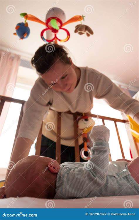 mother checking  newborn baby   bed stock photo image