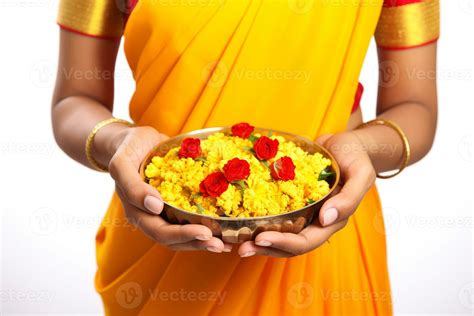 A photo of a beautiful mature indian woman holding marigold flowers in