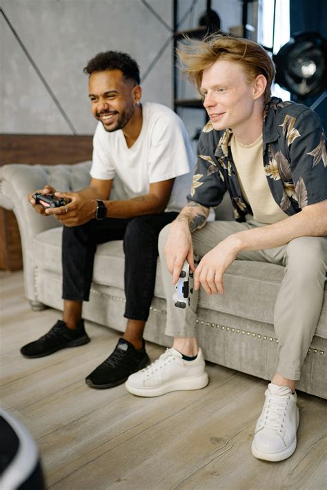 men sitting   couch  stock photo