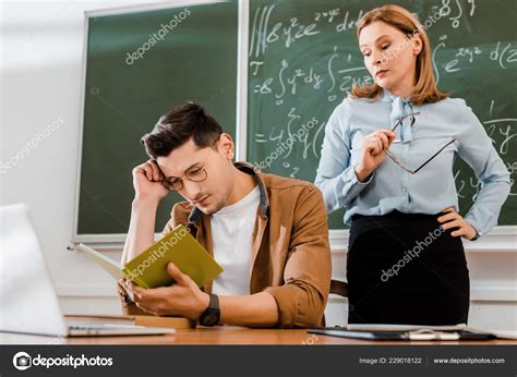 Student Glasses Sitting Desk Looking Notebook Teacher Stock Photo by ...