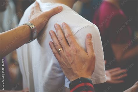People praying together at Church. Stock Photo | Adobe Stock