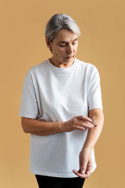 photo medium shot woman applying cream  arm