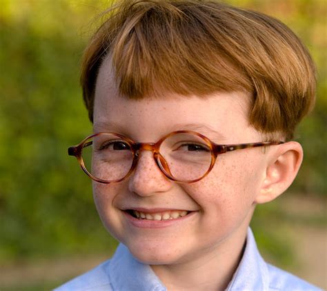 boy redhead freckles happy  glasses child smiling wearing