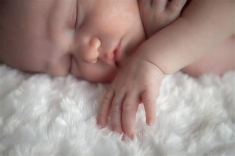 premium photo newborn baby sleeps sweetly  light background