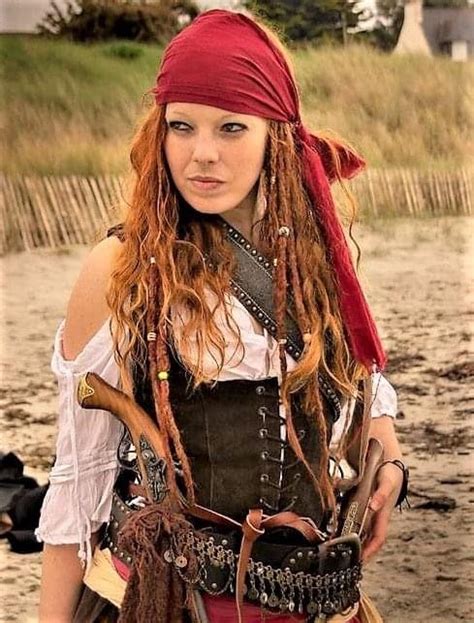 a woman with red hair wearing a pirate costume