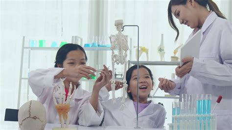 Asian schoolgirls are studying science and technology in a lab