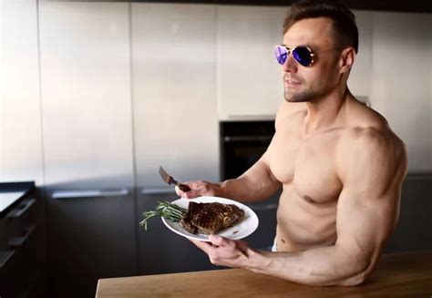 Man ready to eat cut with fork and knife grill beef steak on a kitchen ...