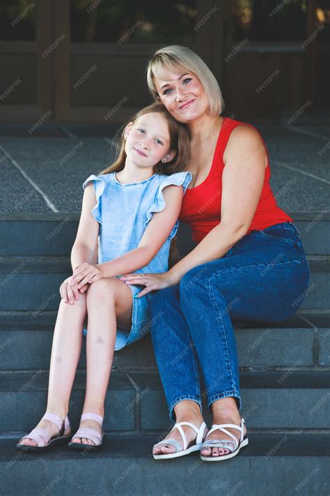 Premium Photo | Beautiful blonde mom in a red t-shirt with her daughter
