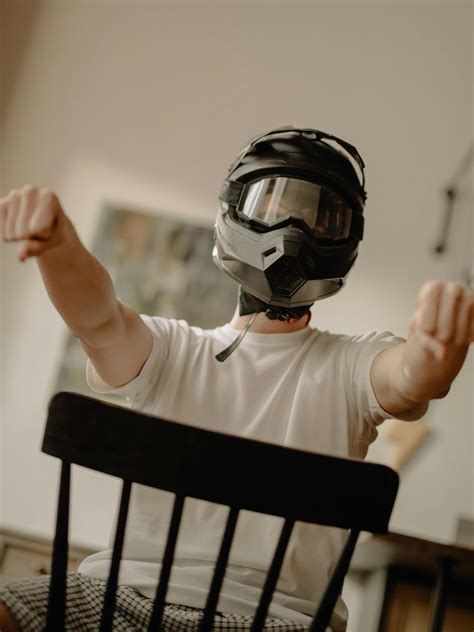 Man in White Long Sleeve Shirt Wearing Black Helmet · Free Stock Photo