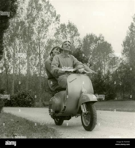 advertising piaggio vespa  couple   vespa rome italy stock