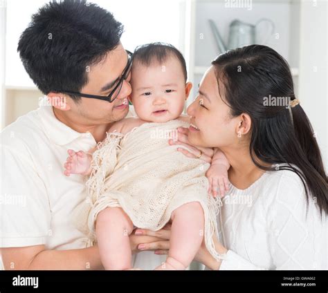 Parents kissing baby Stock Photo - Alamy