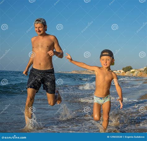 Father and Son Playing on the Beach, Having Quality Family Time