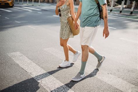 Stylish couple crossing road on crosswalk in sunny day · Free Stock Photo