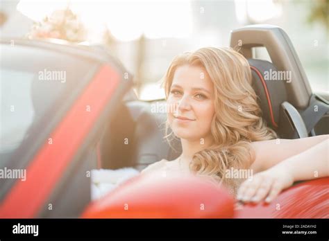 close up. beautiful young woman in wedding dress sitting in car. photo with copy space Stock ...