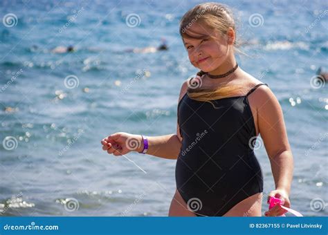 Little Girl in Black Swimsuit Standing in the Sea Stock Image - Image ...