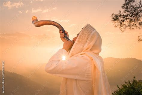 A Jewish man blowing the Shofar (ram's horn), which is used to blow sounds on Rosh HaShana (the ...