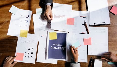 Premium Photo | Marketing strategy paperworks on the table