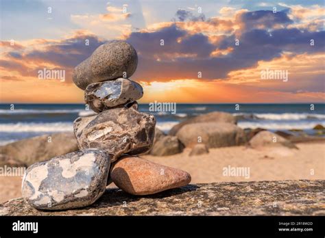 Stone pyramids and glass sphere on the dreamy Baltic Sea sand beach on ...