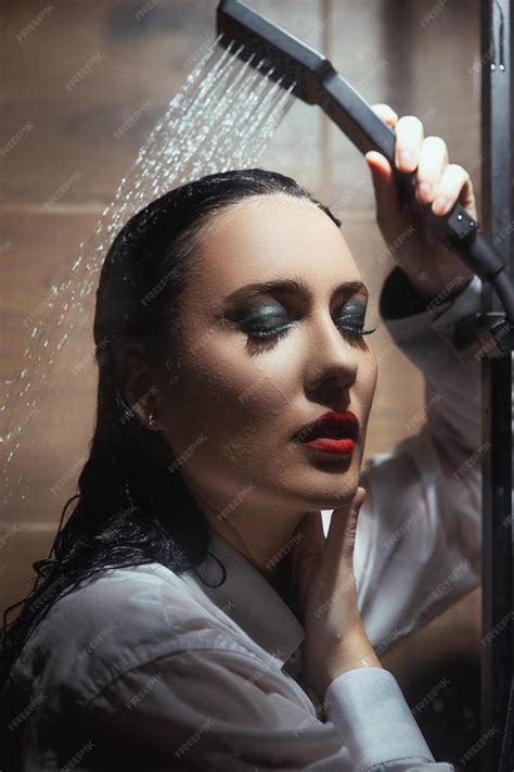 Premium Photo | A woman is showering in a shower with a shower head.