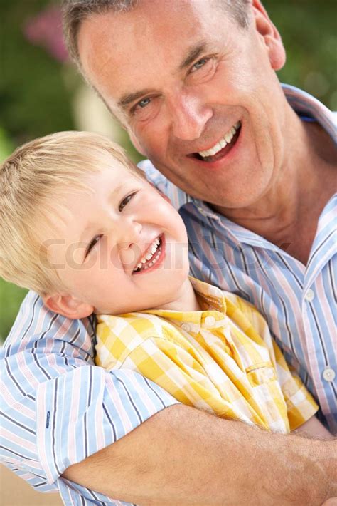 Grandfather And Grandson Relaxing On Sofa Together | Stock image ...