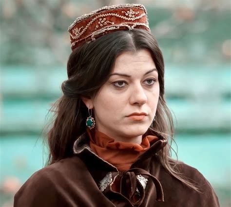 a woman wearing a tiara and looking off into the distance