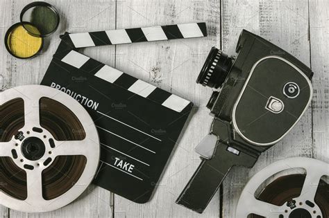 Old movie camera and film reel containing camera, film, and movie ...