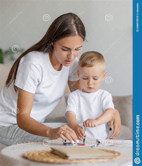 Mom and Son at Home in the Living Room Hugging and Playing. Parenthood
