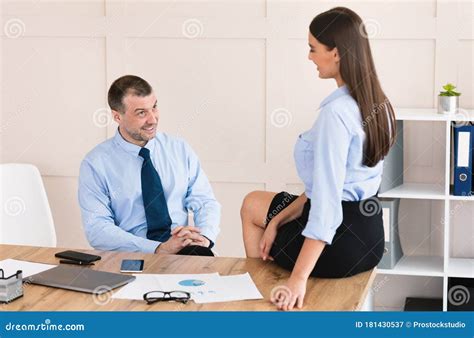 Lustful Boss Flirting Seducing Colleague at Workplace in Office Stock