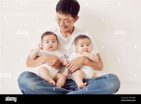 father holding baby twins stock photo alamy