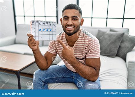 Young Indian Man Holding Travel Calendar Smiling Happy Pointing with ...