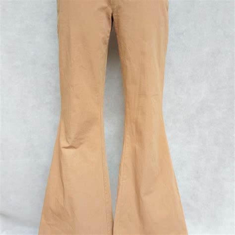 Brown flared Esprit pants. HIgh waist. Closes with a... - Depop