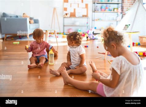 adorable toddlers sitting   floor playing  lots  toys