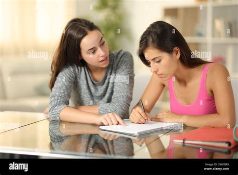 Private teacher explaining lesson to a student at home Stock Photo - Alamy