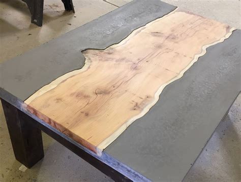 a table made out of wood and metal with a large slab on it's side