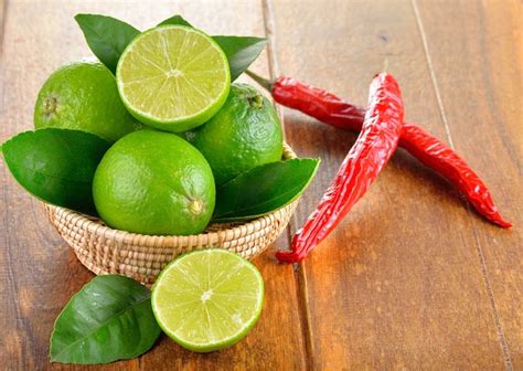 premium photo fresh lime  red chilli  wooden background