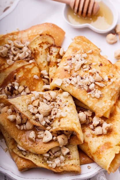 Premium Photo | Pancakes with nuts and honey