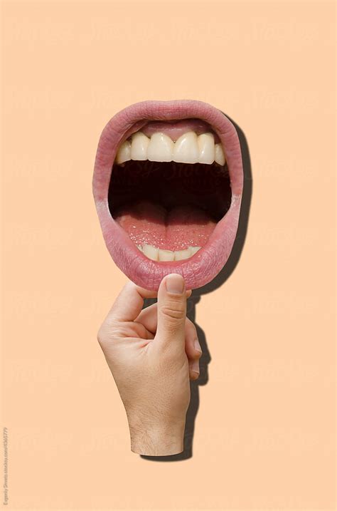 hand holding mouth  stocksy contributor evgeniy shvets stocksy