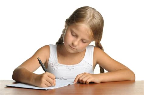 The girl writes to writing-books. The decision of lessons. Stock Photo ...