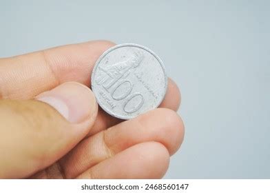 indonesian coins worth  rupiah hand stock photo