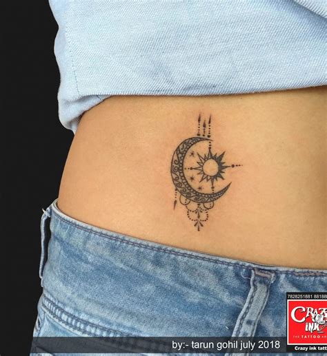 magnificent moon and sun tattoo on girl belly button for girl tattoo