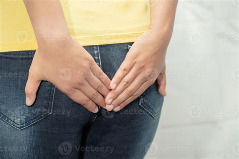 The woman was suffering from hemorrhoids and put her hand on her