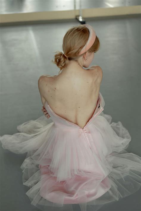 Woman in Pink Ballet Costume Sitting On Floor · Free Stock Photo