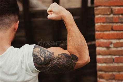 Strong Guy with a Tattoo on His Arm Outside Stock Image - Image of ...