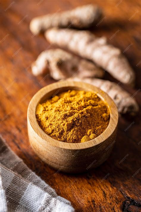 Premium Photo | Indian turmeric powder and root turmeric spice ground