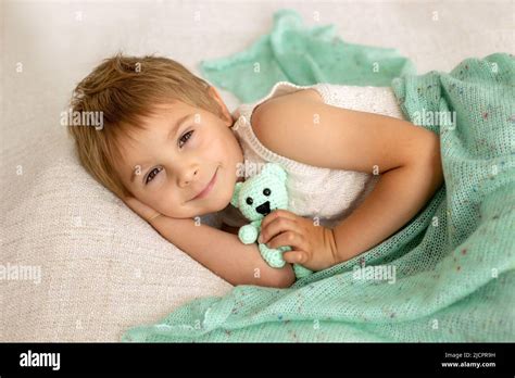 Little toddler child, cute kid with knitted small cute animal toy ...