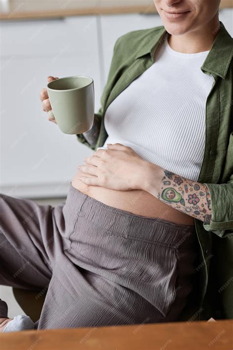 Premium Photo | Closeup of tattooed pregnant woman relaxing in morning