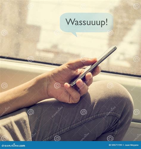 Young Man Sending a Text Message with the Text Wassuuuup Stock Image