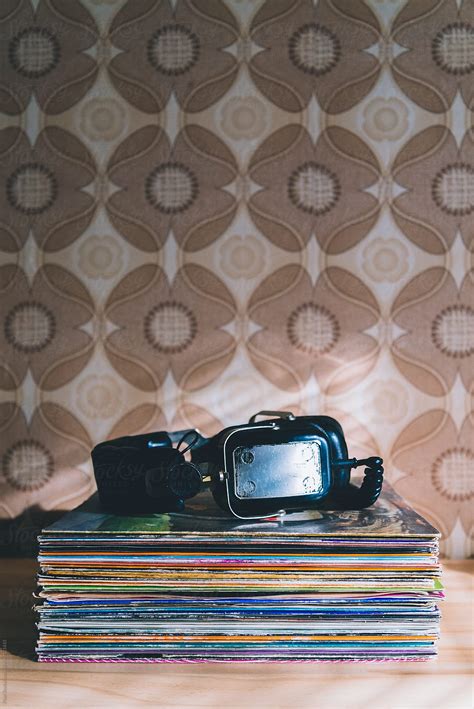 "Big Vintage Headphones On Stacked Vinyl Music Record Albums" by